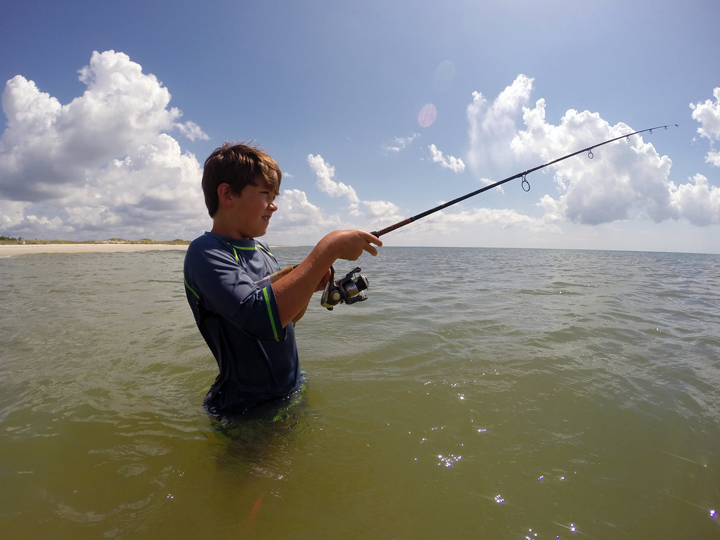 kid practicing fly fishing under the water