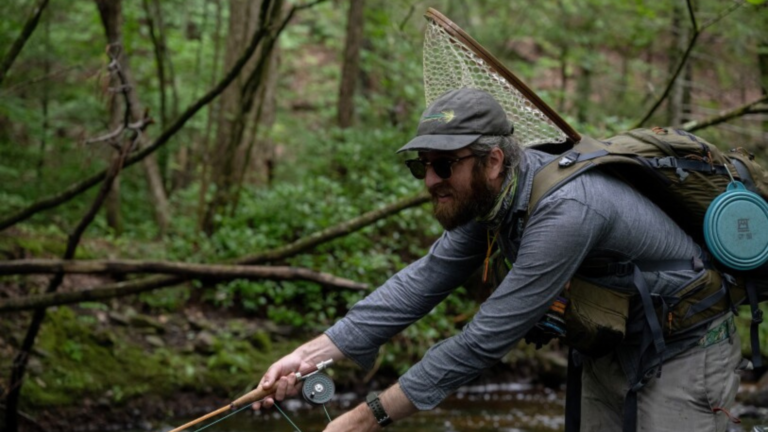 man practicing fly fishing